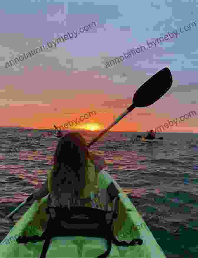 A Canoeist Paddles Towards The Setting Sun On A Tranquil Lake Canoeing The Mountain: Gifts From The Waters