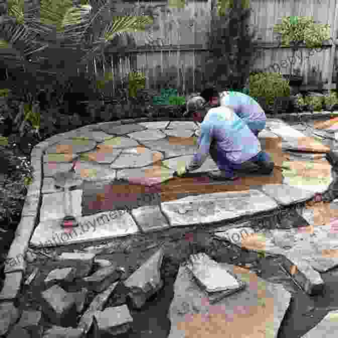 A Crew Installing A Patio Made Of Natural Stone. Encyclopedia Of Landscape Design: Planning Building And Planting Your Perfect Outdoor Space